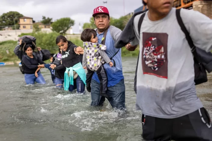 104493092-eagle-pass-texas-september-30-immigrants-from-venezuela-cross-the-rio-grande-from-mexico